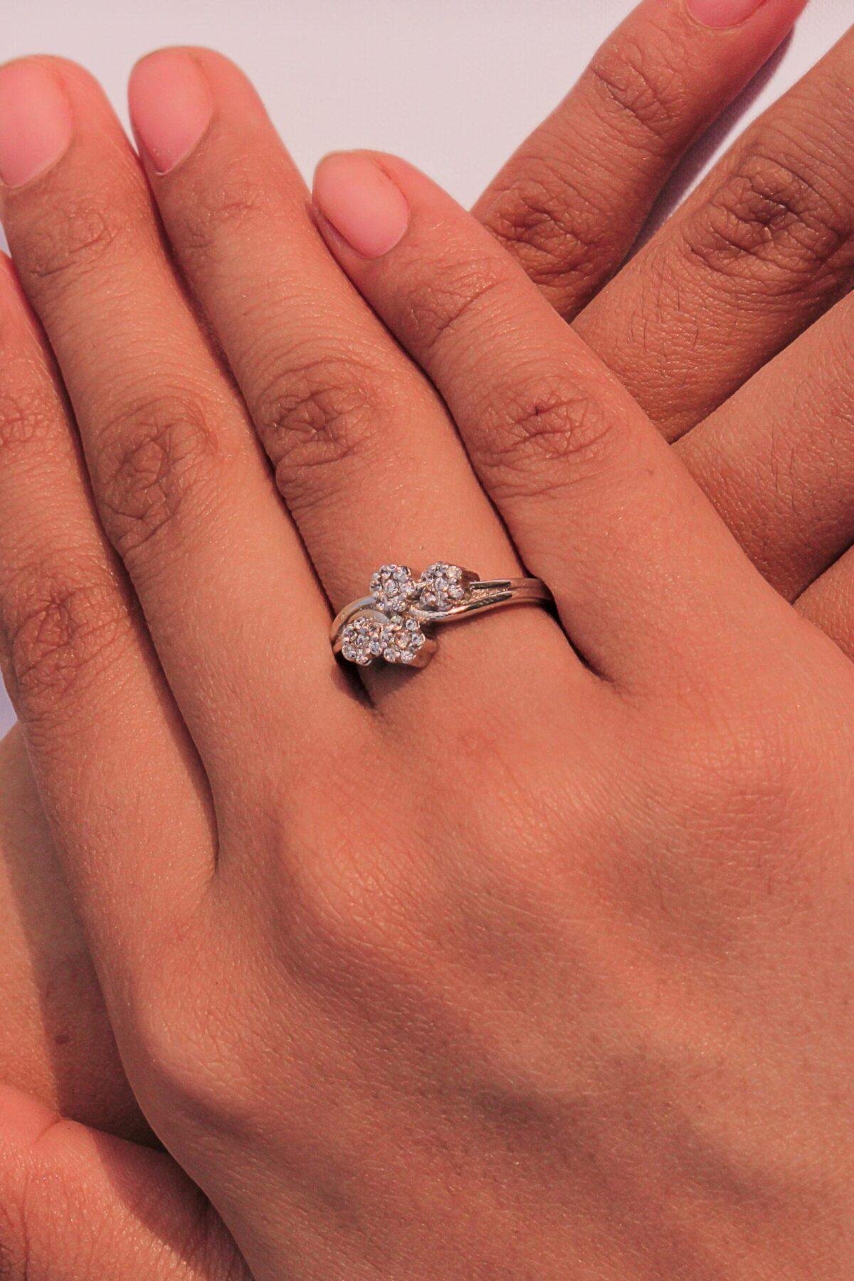 model wearing Floral Design Ring featuring 1.35mm zircon stones, handcrafted in 925 silver