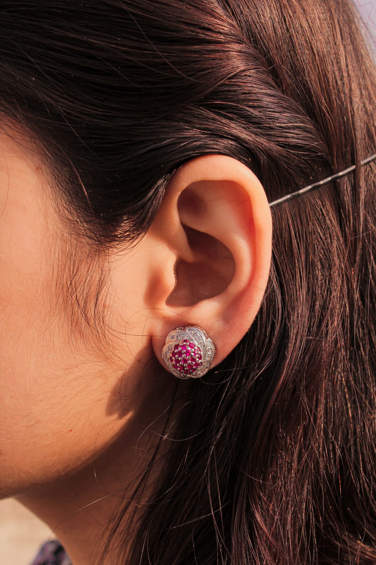 model wearing Sparkling Cluster Twist Earrings 1.75mm center pinkish stones crafted in 925 silver with rhodium plating