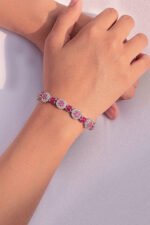 model wearing The Deep Pinkish Crimson Glory Bracelet 1.50mm center stones with rhodium plating